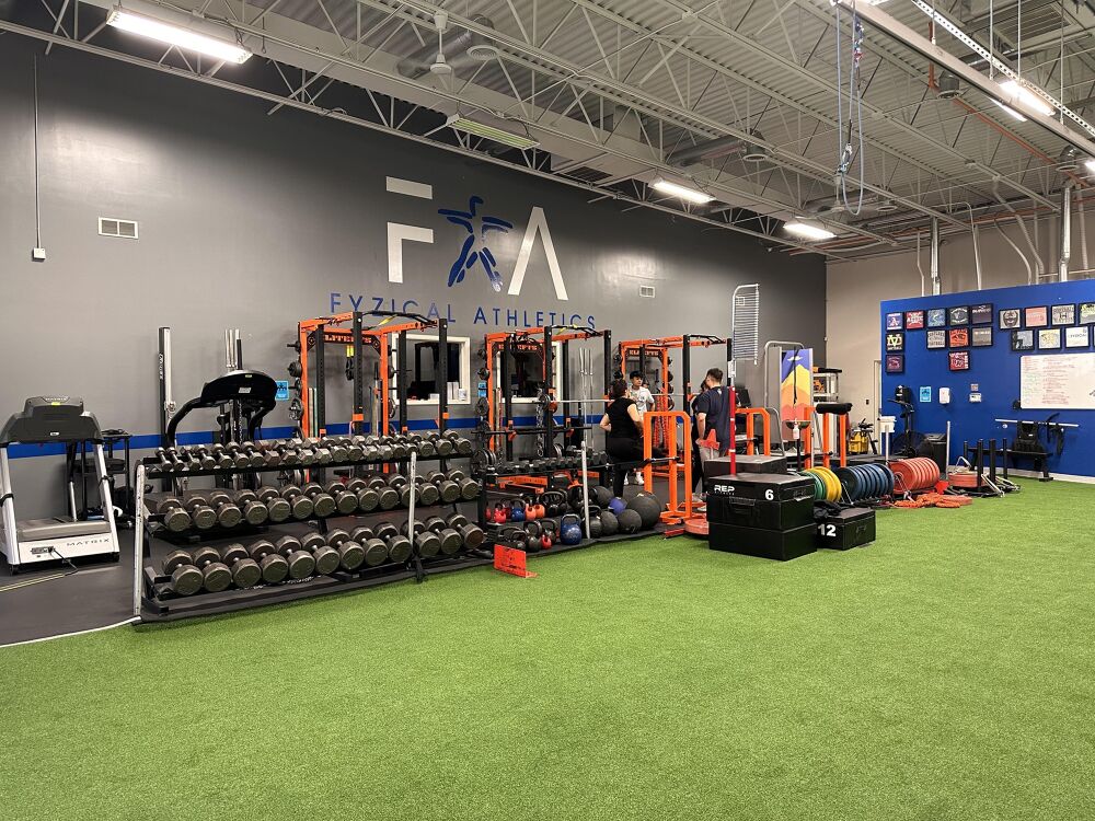 Strength training equipment and turf inside Fyzical Athletics